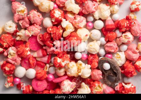 Colorful red and pink candied popcorn with mixed candies pile Stock Photo