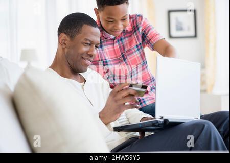 Father and son shopping online Stock Photo