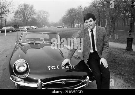 Tony Blackburn, Radio One disc jockey, pictured in Hyde Park, London. He is seen with his new E-Type Jaguar - the registration number is the same as the Radio One band - 247. 20th February 1968. Stock Photo