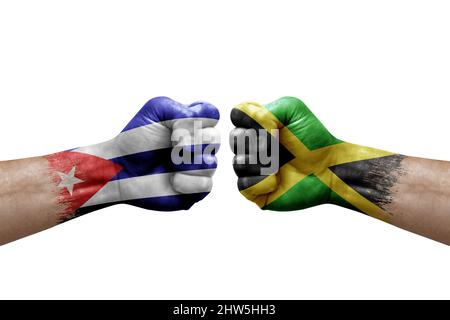 Two hands punch to each others on white background. Country flags painted fists, conflict crisis concept between cuba and jamaica Stock Photo