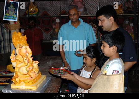 Mumbai Maharashtra India Asia Sep. 2007 Happy Indian Family Celebrating Ganesh Festival or Chaturthi Welcoming or performing Pooja in workshop Stock Photo