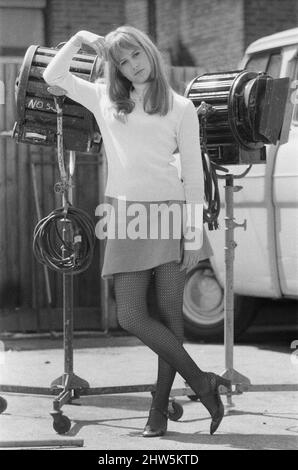 Actress Susan George, pictured on the film set during a filming break in Tooting High Street, London.  She is filming at a pub called The Castle. Susan George is 17 years old in these pictures, and will soon appear in the 1969 released film 'All Neat in Black Stockings'  Picture taken 14th May 1968 Stock Photo