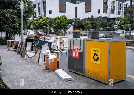 Brisbane, Queensland, Australia - Mar 4, 2022: Flood damaged house goods dumped on the side of the road for collection Stock Photo