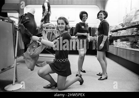 The management at Lewis's store, Liverpool, have received complaints about the shortness of mini dresses worn by their sales assistants in the Miss Selfridge shop for young people. Sales assistants Penny Hobson, Beatrice Rees and Kathy Loughlin are pictured. 21st November 1967. Stock Photo