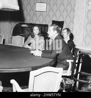 The Avengers Line, Fashion Show at The Palm Beach Casino, London, 4th January 1967. The clothes on display have been inspired by ABC Television Series The Avengers. Pictured, actors Diana Rigg - aka Emma Peel and John Steed - aka Patrick Macnee - watch the show. Stock Photo