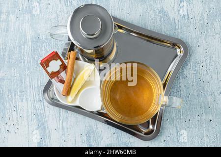 Hot winter tea served with a french press on a wooden table Stock Photo