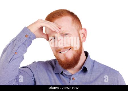 Red-haired man with beard and headache looking at the camera. High quality photo Stock Photo