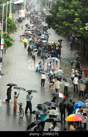 Monsoon, people walking through flooded road heavy rain in Parel ...