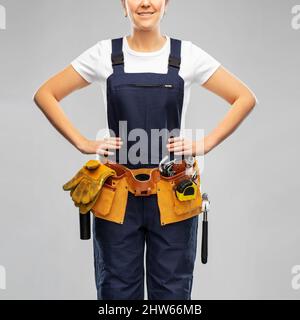 female worker or builder with working tools Stock Photo