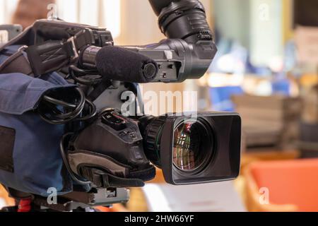 Professional TV video camera on a tripod. Close up. Selective focus Stock Photo