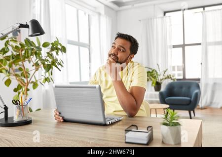 indian man with laptop working at home office Stock Photo
