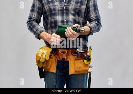 male repairer or builder with drill and work tools Stock Photo