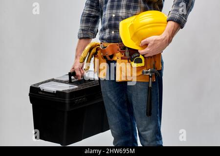 builder with helmet and box of working tools Stock Photo