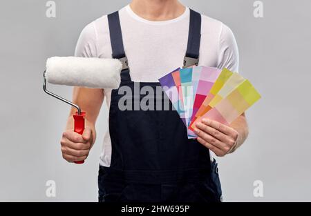 close up of painter with roller and color charts Stock Photo
