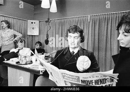 BBC Radio One Rehearsals ahead of official launch, Studio Scenes, Broadcasting House, London, 28th September 1967.  Radio One went on to launch at 7:00 am on Friday 30 September 1967. The first disc jockey to broadcast on the new station was Tony Blackburn, and the first The first record played was 'Flowers in the Rain' by The Move.  Pictured, DJ Kenny Everett in studio reading the latest music news in Melody Maker Music Newspaper.  Picture taken 28th September 1967 Stock Photo