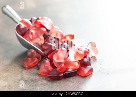 Heart shaped jelly candy in metal scoop. Stock Photo