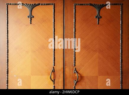 Decorative details of an old wooden cabinet, closeup view. Stock Photo