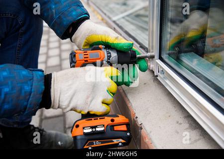 The wizard is engaged in installing windows. Repair work. Stock Photo