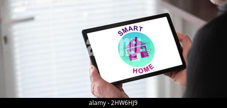 Smart home concept shown on a tablet held by a man Stock Photo