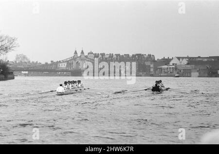 The Oxford verses Cambridge Boat Race, on the River Thames, March 1968.   Picture shows the canoes approaching Hammersmith Bridge. The 114th Boat Race took place on 30 March 1968. Held annually, the event is a side-by-side rowing race between crews from the Universities of Oxford and Cambridge along the River Thames. The race, umpired by Harold Rickett, was won by Cambridge by three-and-a-half lengths. Goldie won the reserve race and Cambridge won the Women's Boat Race.  The race was held from the starting point at Putney Bridge on The River Thames in London, to the finish line at Chiswick Bri Stock Photo
