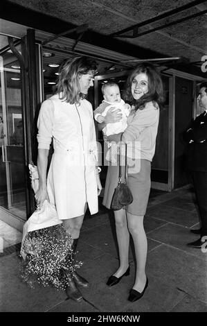 Vanessa Redgrave was at Heathrow Airport holding a baby. On investigation it turned out that she took her nephew, 5-month-old Benjamin to meet his mother Lynn Redgrave, who was arriving from Singapore with her mother Lady Redgrave. They had been filming in the Far East. Everybody had a little cry, then they gave each other enormous bunches of flowers and put funny hats on the baby's head. 5th October 1968. Stock Photo