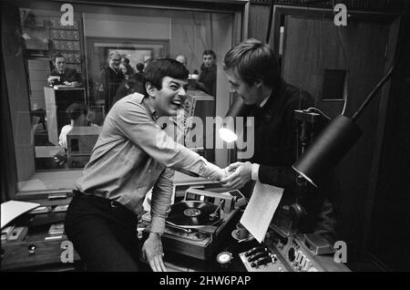 Tony Blackburn, the 22 year old Disc Jockey, finishes his  broadcast of the very first show on BBC Radio One.He is left in this picture, and being congratulated by Simon Dee  The BBC, Radio One launched at 7am. Friday 30th September 1967  Picture taken Friday 30th September 1967 Stock Photo