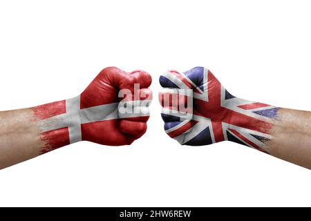 Two hands punch to each others on white background. Country flags painted fists, conflict crisis concept between denmark and united kingdom