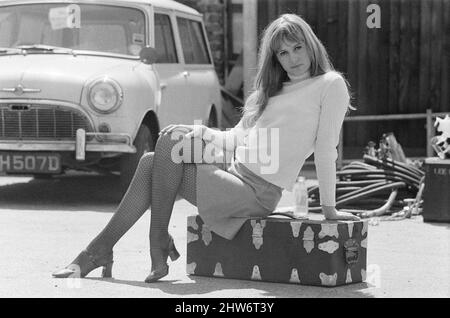 Actress Susan George, pictured on the film set during a filming break in Tooting High Street, London.  She is filming at a pub called The Castle. Susan George is 17 years old in these pictures, and will soon appear in the 1969 released film 'All Neat in Black Stockings'  Picture taken 14th May 1968 Stock Photo