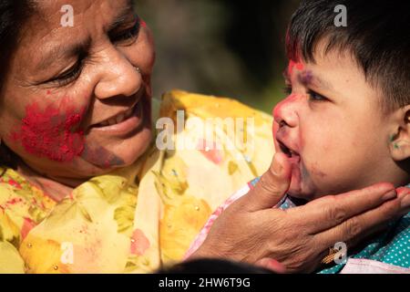 Elderly Indian Lady And Kid Enjoying Holi With Gulal Or Abir Rang Abeer. Festive, Family, Fun, Celebration, Enjoyment, Togetherness, Multi Generation