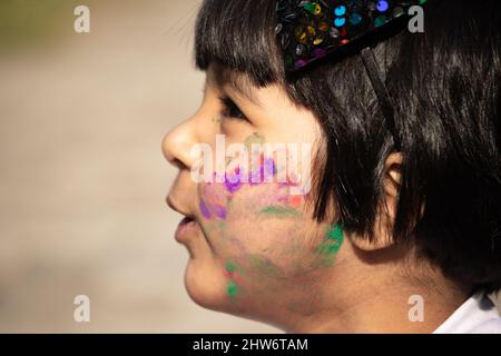 Indian Festive Theme - Happy Asian Kid Baby Girl Having Fun With Non Toxic Herbal Holi Color Powder Called Gulal Or Abir Rang Abeer Stock Photo