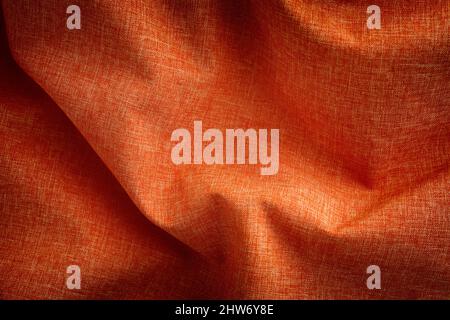 Red crumpled fabric background. Close up. Stock Photo