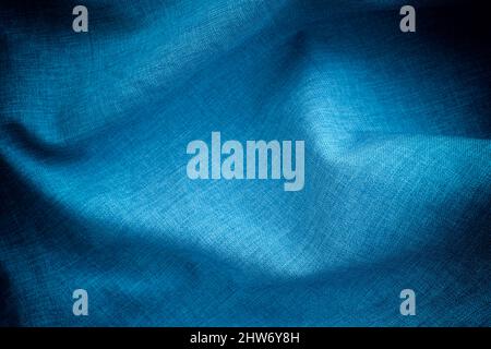Dark blue crumpled fabric background. Close up. Stock Photo