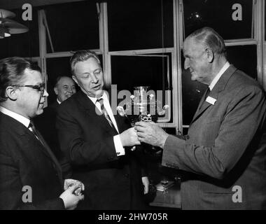 Visiting dignitary, Mr Burkov (centre), Head of Novosti Agency, presents a russian tea urn, a Samovar, to Cecil King, Chairman of Daily Mirror Newspapers, Sunday Pictorial Newspapers and the International Publishing Corporation (1963-68), at Holborn, London, 3rd December 1967. Also pictured, Anatoly Uglov, London Correspondent for Novosti. Stock Photo