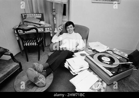 Tony Blackburn, the 22 year old Disc Jockey, at his flat in Knightsbridge, London, relaxing with his records. Tony Blackburn recently launched BBC, Radio One launched at 7am. Friday 30th September 1967.  Picture taken Saturday 1st October 1967 Stock Photo