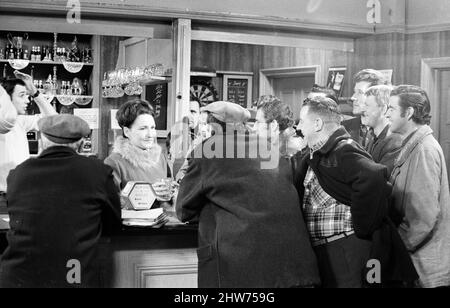 The cast of 'Coronation Street' on set. Eileen Derbyshire behind the bar at the Rovers Return. 16th April 1968. Stock Photo