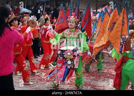 (220304) -- WEINAN, March 4, 2022 (Xinhua) -- Villagers take part in a Shehuo performance in Ashou Village, Qiangbai Township, Dali County, Weinan City, northwest China's Shaanxi Province, March 3, 2022. The Shehuo parade, a time-honored performance enjoying widespread popularity in rural areas across China, originated from ancient sacrificial activities to pray for a good harvest about 2,000 years ago.   It is a folk custom in multiple forms consisting of dragon dance, lion dance, Yangko dance, drum playing and other folk performances that may vary in different regions. (Xinhua/Tao Ming) Stock Photo