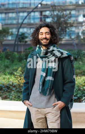 Portrait of a confidence businessman looking at the camera and smile while posing outdoors on the street. Stock Photo