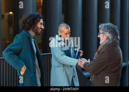 Professional business people talking and meeting on the street. Stock Photo