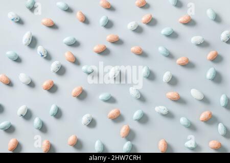 Easter pattern with pastel chocolate eggs on blue background. Religion tradition. View from above. Flat lay style. Stock Photo