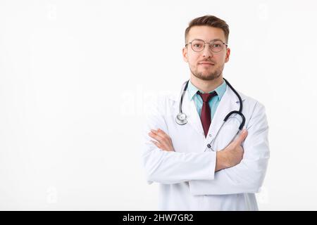 Portrait of confident young medical doctor on white background. Stock Photo