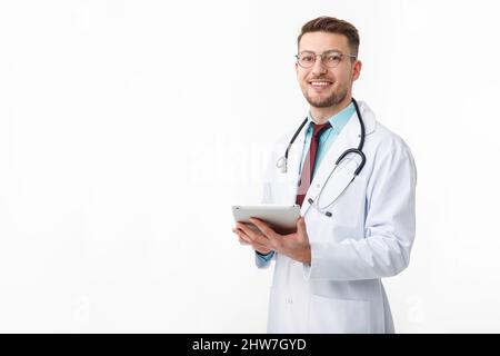 Portrait of confident young medical doctor on white background. Holding a tablet in his hands Stock Photo