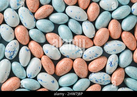 Easter pattern with pastel chocolate eggs on blue background. Religion tradition. View from above. Flat lay style. Stock Photo