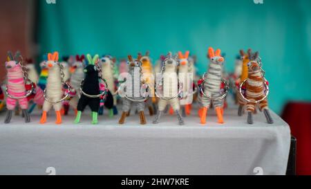 Quito, Pichincha, Ecuador - February 26 2022: Group of wool llamas made by hand by indigenous Ecuadorians for sale in an artisan market Stock Photo
