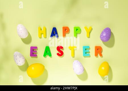 Easter card. Multicolored letters making the words Happy Easter and colorful eggs. Top view Stock Photo