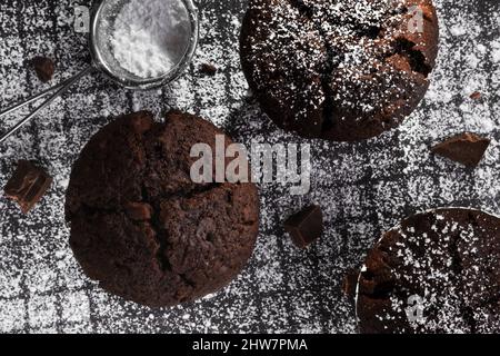 Top view Freshly baked chocolate muffins on a dark background Stock Photo