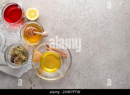 Herbal tea, green tea, fruit tea cups on grey background Stock Photo