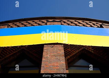 Ukrainian ensign, national flag on a vintage building, ukrainian war, solidaritiy symbol Stock Photo