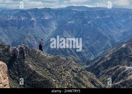 Ziplining at Divisadero, Copper Canyon, Chihuahua, Mexico. 8350 feet long, longest zip line in the world.  Speed may reach 70 mph on the descent. Zip Stock Photo