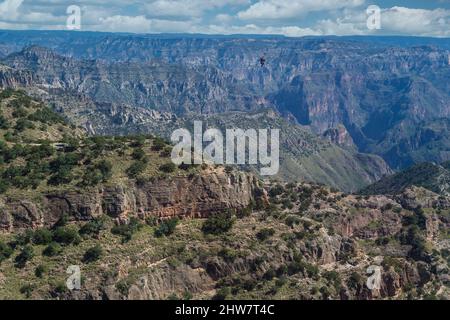 Ziplining at Divisadero, Copper Canyon, Chihuahua, Mexico. 8350 feet long, longest zip line in the world.  Speed may reach 70 mph on the descent. View Stock Photo