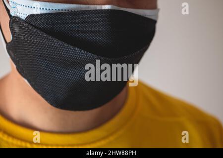 Double masking helps to improve the fit and filtration of first mask. Protection global pandemic of coronavirus. Other name of this disease calls COVI Stock Photo